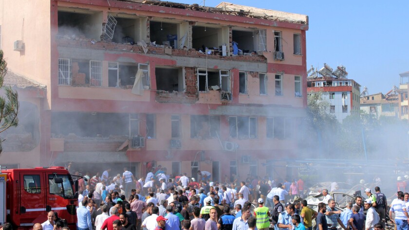 Rescue workers and residents gather after a car bomb attack on a police station in the eastern Turkish city of Elazig.