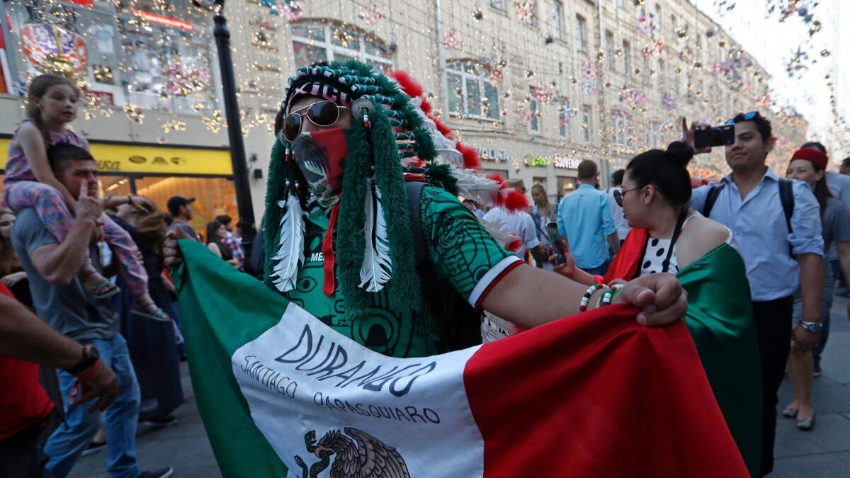 A fan of Mexico walks on Nikolskaya Street near the Kremlin, dubbed the "Street of Light," one of the favorite meeting points in the Russian capital for soccer fans during the 2018 FIFA World Cup.