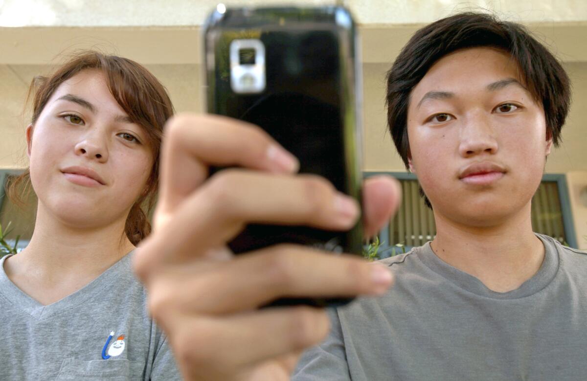 Portrait of Young Cho, left, 16, of Glendale and Christopher Chung, right,16, also of Glendale in front of their school Herbert Hoover High School in Glendale, CA on September 12, 2013.