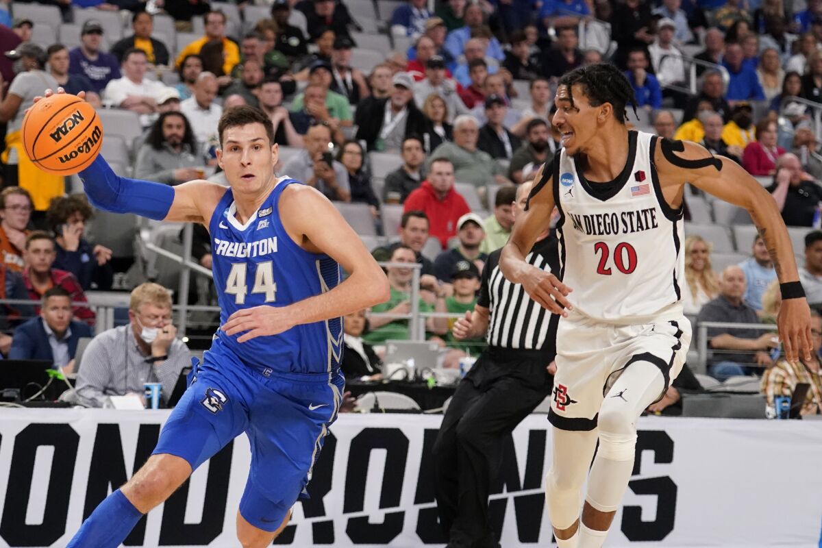 Creighton forward Ryan Hawkins breaks to the basket as San Diego State guard Chad Baker-Mazara defends.