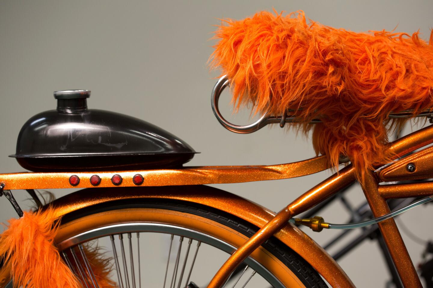 Activist General Dogon builds custom bikes as a way of drawing attention when he is canvassing Skid Row for the Los Angeles Community Action Network (LA CAN). Seen here: 'Homeless Mobile,' a vintage Western Flyer with fur-covered seat and metal flake orange paint.