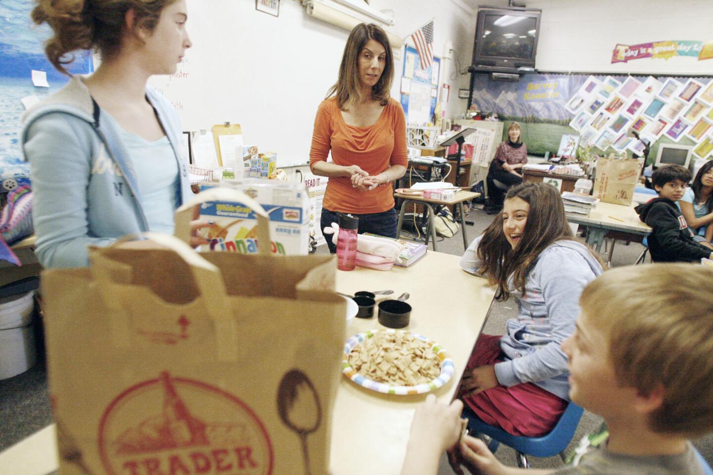 Wendy Crump, from top center (clockwise), asks sixth-grade students Brittany Lerian, Timmy Fejtek and Rebecca Klein questions about the nutritional label at La Canada Elementary School on Wednesday, February 22, 2012. The school celebrated nutrition week. "We empower children to make healthy food choices," Crump says. Crump is a registered nutritionist.