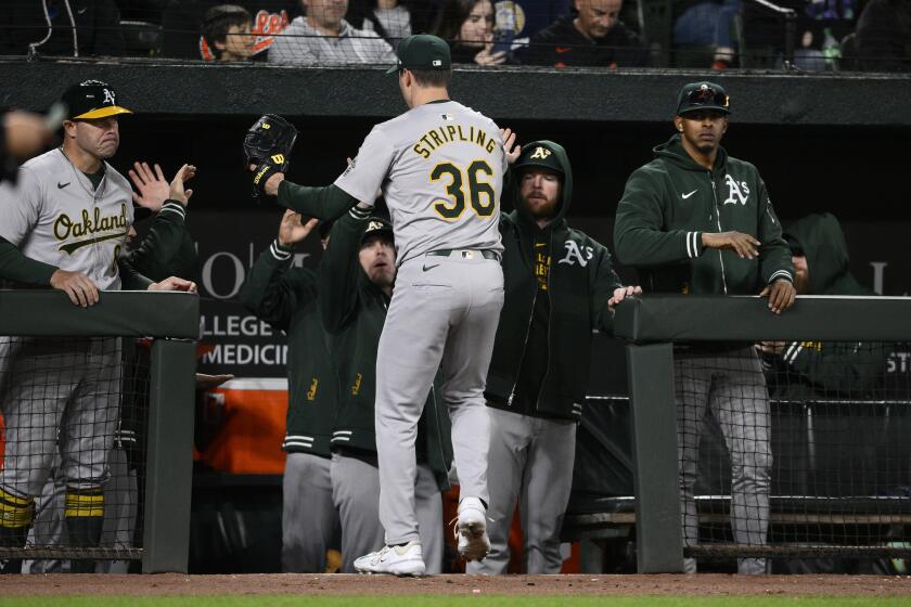Oakland Athletics starting pitcher Ross Stripling (36) is greeted by teammates after he was pulled during the sixth inning of a baseball game against the Baltimore Orioles, Friday, April 26, 2024, in Baltimore. (AP Photo/Nick Wass)