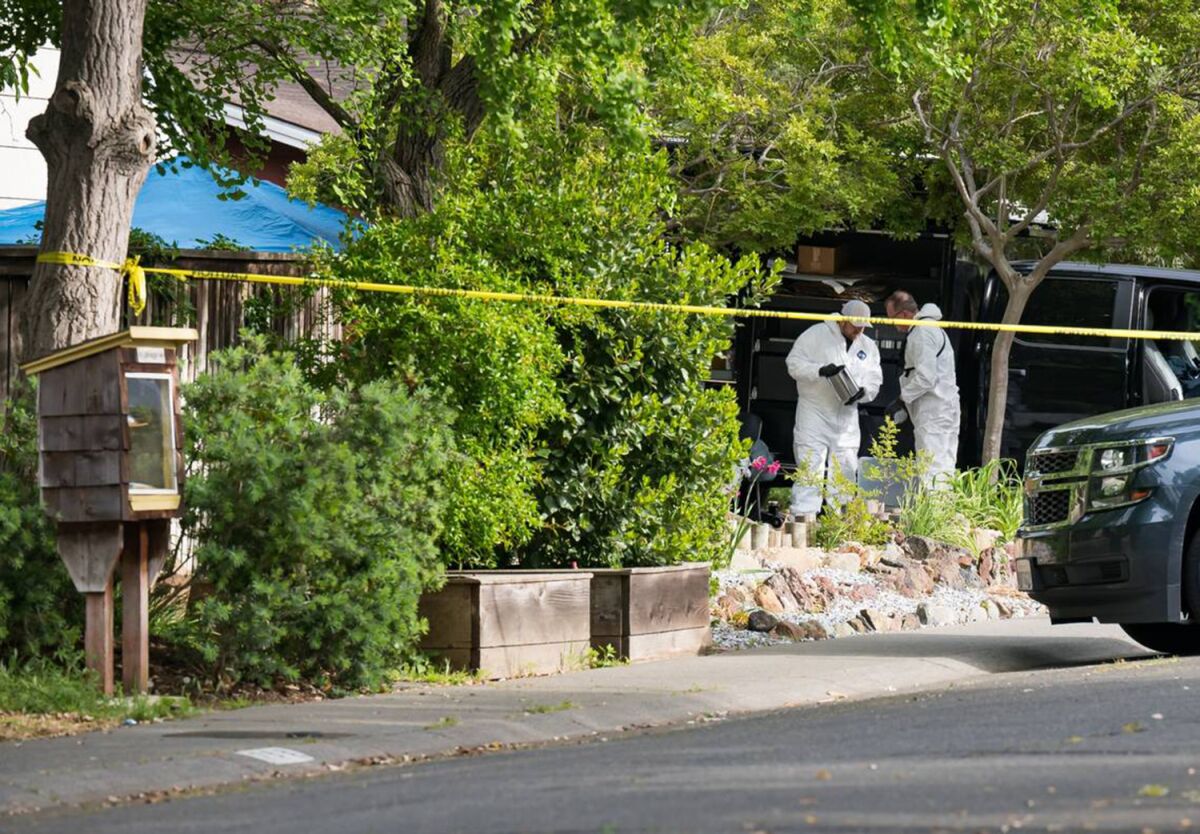 Investigators catalog items at the Davis rental home where suspect Carlos Reales Dominguez lived.