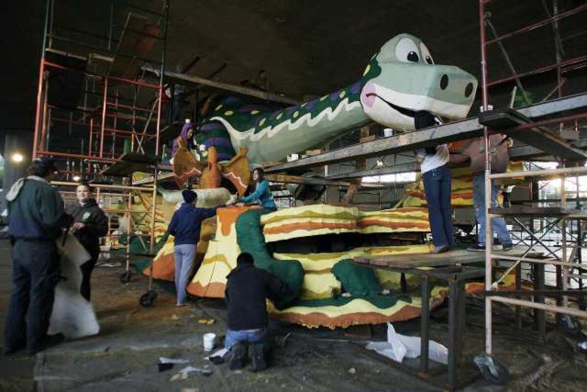 The La Canada Flintridge float, "Dino-Soar," under construction days before the 124th Rose Parade.