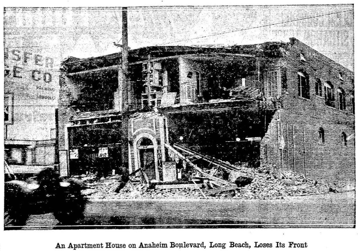 1933 image of  Long Beach apartment building with the front missing, exposing a cross section of apartments 