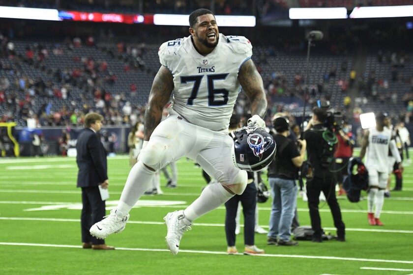 Tennessee Titans guard Rodger Saffold (76) celebrates with fans after their win over the Houston Texans in an NFL football game, Sunday, Jan. 9, 2022, in Houston. (AP Photo/Justin Rex )