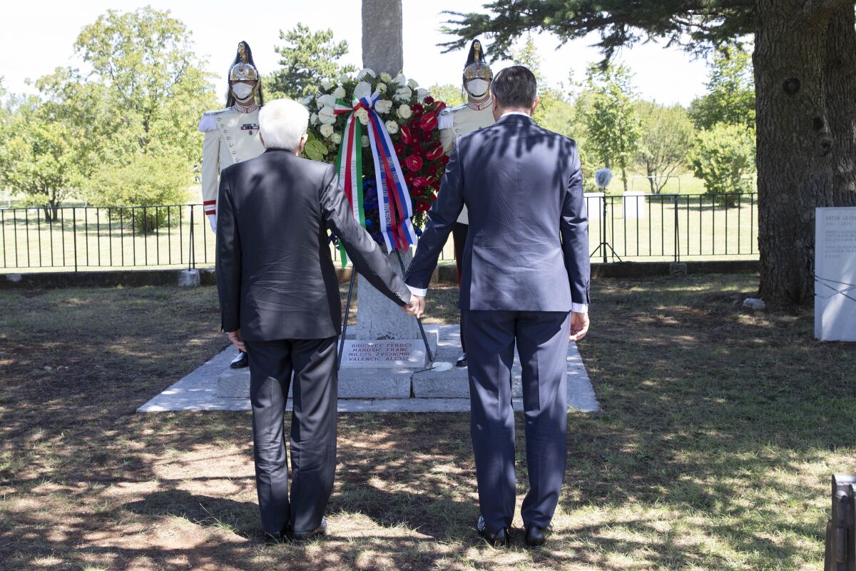 Slovenian President Borut Pahor and Italian President Sergio Mattarella, left, hold hands in Basovizza, near Trieste, Italy, Monday, July 13, 2020. The presidents of Italy and Slovenia met a several ceremonies on Monday linked to sorrowful incidents in their nations history and aimed at reinforcing reconciliation. In the area of Trieste, a port city near Italy’s border with Slovenia, Italy’s Sergio Mattarella and Slovenia’s Borut Pahor held hands and observed a minute of silence at a monument to four anti-Fascist Slovenes, who were executed by Italian dictator Benito Mussolini’s regime in 1930. The four became symbols the Slovene minority's resistance to Italian Fascism. (Francesco Ammendola, Italian Presidency via AP)