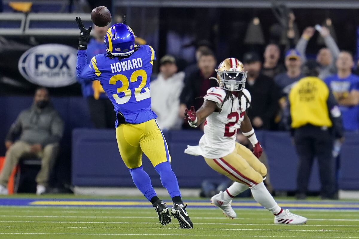 FILE - Los Angeles Rams' Travin Howard (32) intercepts a pass in front of San Francisco 49ers' JaMycal Hasty during the second half of the NFC Championship NFL football game, Jan. 30, 2022, in Inglewood, Calif. The Rams have waived Travin Howard. The team announced the move Wednesday, June 8, 2022 after the final on-field workout of their offseason program. (AP Photo/Marcio Jose Sanchez, file)