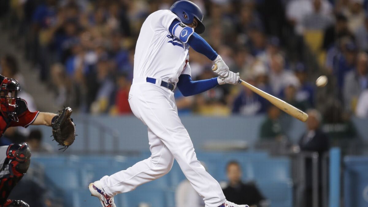 Los Angeles Dodgers' Cody Bellinger connects for a two-run home run during the eighth inning of a baseball game against the Washington Nationals.