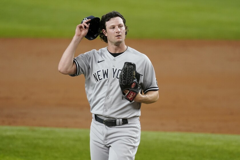 New York Yankees starting pitcher Gerrit Cole adjust his cap as he works against the Texas Rangers in the third inning of a baseball game in Arlington, Texas, Monday, May 17, 2021. (AP Photo/Tony Gutierrez)