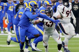 INGLEWOOD, CALIF. - DEC. 25, 2022. Rams running back Malcolm Brown get a big gain against the Broncos in the fourth quarter at SoFi Stadium in Inglewood on Sunday, Dec. 25, 2022. (Luis Sinco / Los Angeles Times)