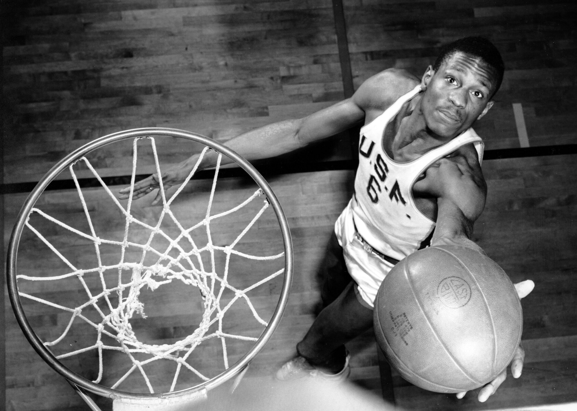 Bill Russell shoots a layup during a photo session at the University of San Francisco.