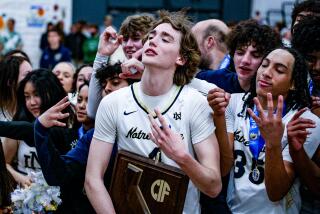 Dusty Stromer of Sherman Oaks Notre Dame holds Division I regional championship plaque.