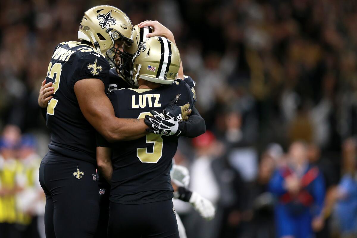 Wil Lutz celebrates with his New Orleans Saints teammates after kicking the winning field goal as time expired against the Carolina Panthers.