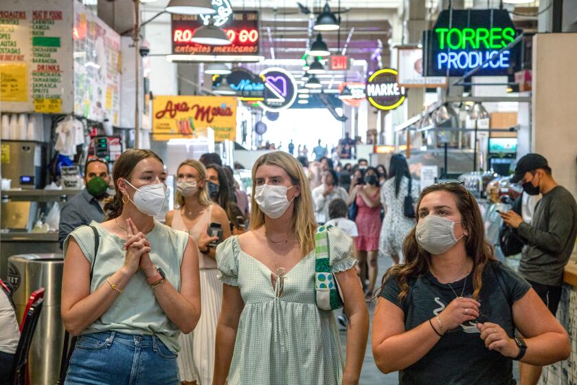 Visitors to the Grand Central Market are mostly masked