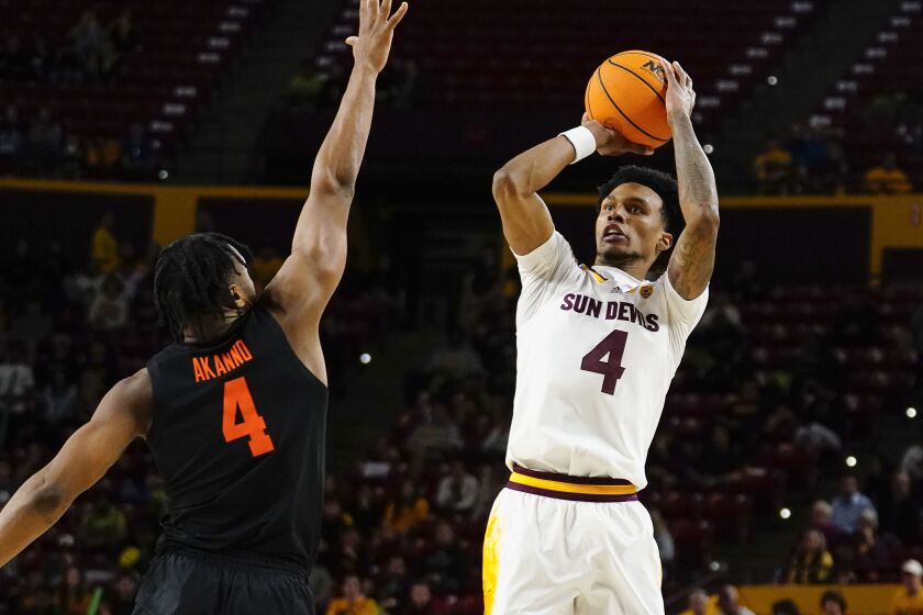 Arizona State's Desmond Cambridge Jr. looks to shoot over Oregon State's Dexter Akanno, left, during the second half of an NCAA college basketball game, Thursday, Feb. 2, 2023, in Tempe, Ariz. (AP Photo/Darryl Webb)