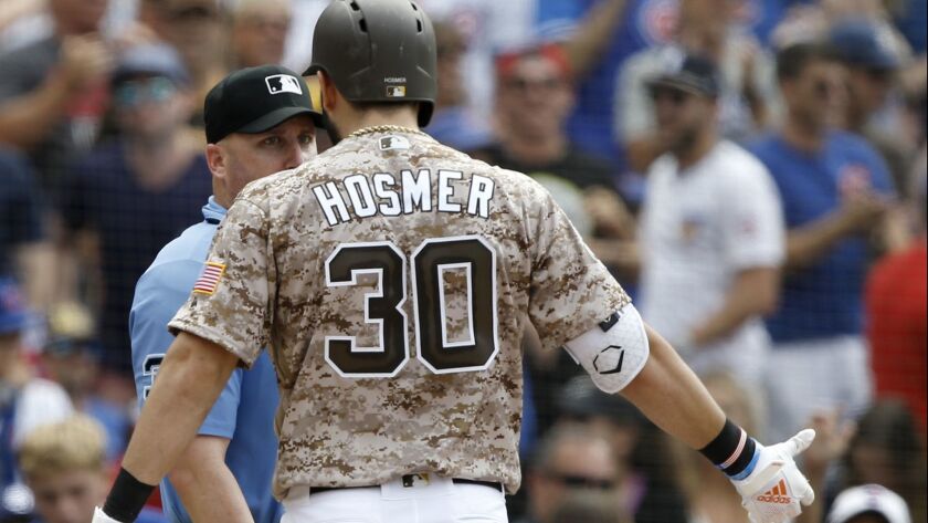 Eric Hosmer has words with home plate umpire Ryan Blakney after being called out on strikes for the final out of Sunday's 7-4 loss to the Chicago Cubs.