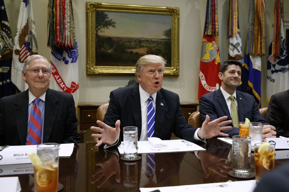 President Trump is flanked by Senate Majority Leader Mitch McConnell (R-Ky.), left, and House Speaker Paul D. Ryan (R-Wis.) at the White House.