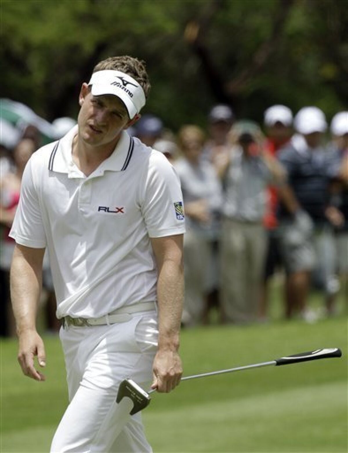 British golfer Luke Donald reacts on the 12th hole during the Nedbank Golf Challenge in Sun City, South Africa on Sunday Dec. 4, 2011. (AP Photo/Themba Hadebe)