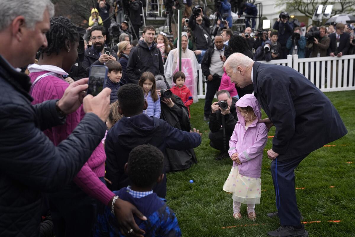 President Biden, right, greets children at the 2024 White House Easter egg roll.