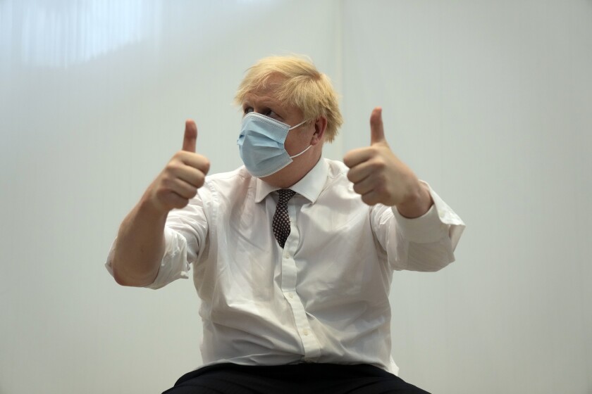 British Prime Minister Boris Johnson gives a thumbs up after receiving his second jab of the AstraZeneca coronavirus vaccine, at the Francis Crick Institute in London, Thursday, June 3, 2021. (AP Photo/Matt Dunham, Pool)