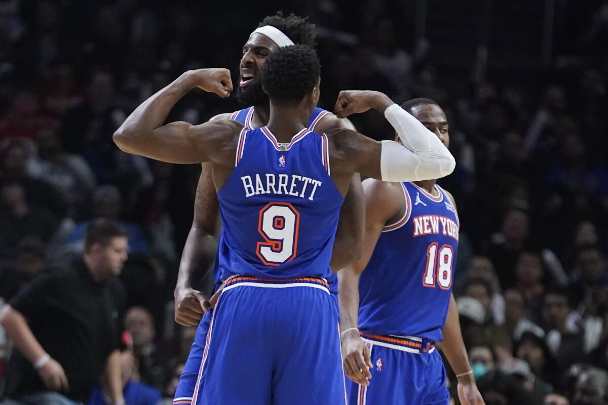 New York Knicks center Mitchell Robinson, center, celebrates his basket with RJ Barrett (9) during the second half of an NBA basketball game against the Los Angeles Clippers Sunday, March 6, 2022, in Los Angeles. (AP Photo/Marcio Jose Sanchez)