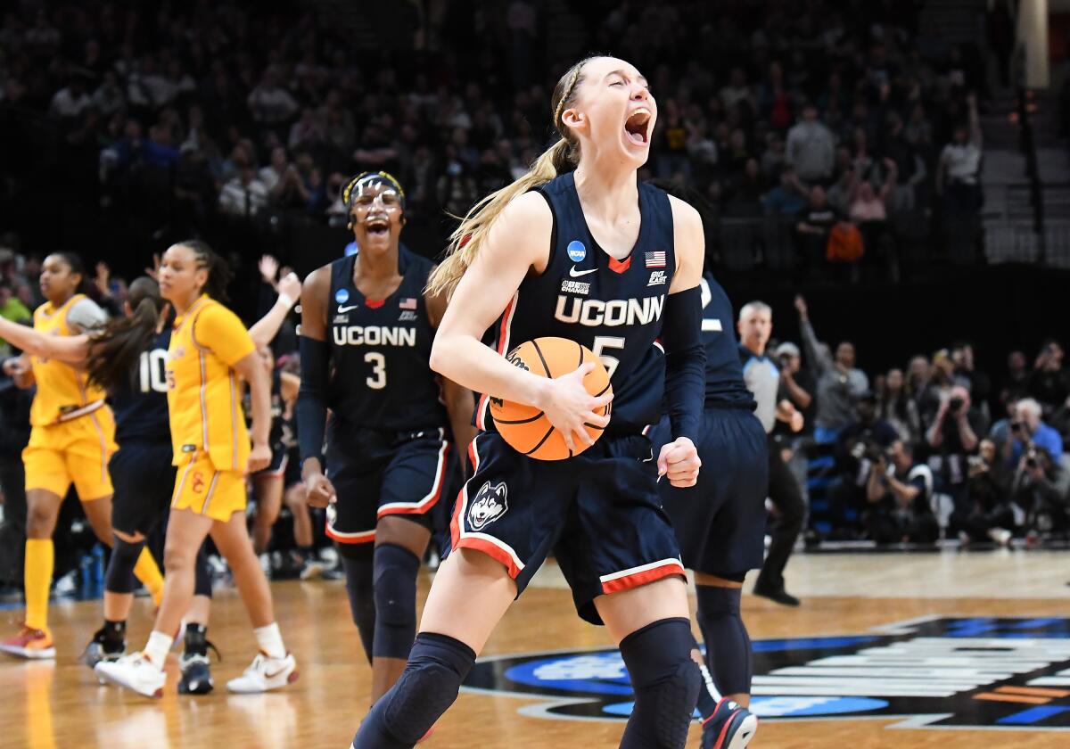Connecticut guard Paige Bueckers celebrates after the Huskies' win over USC in the Elite Eight of the NCAA tournament.
