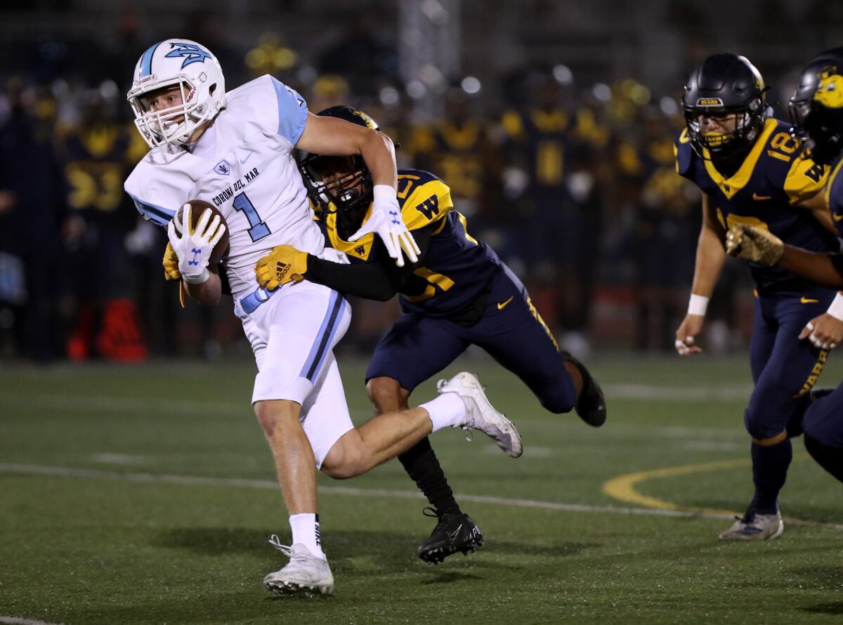 Corona del Mar's Max Lane gets caught from behind by Marquise Villahermosa.