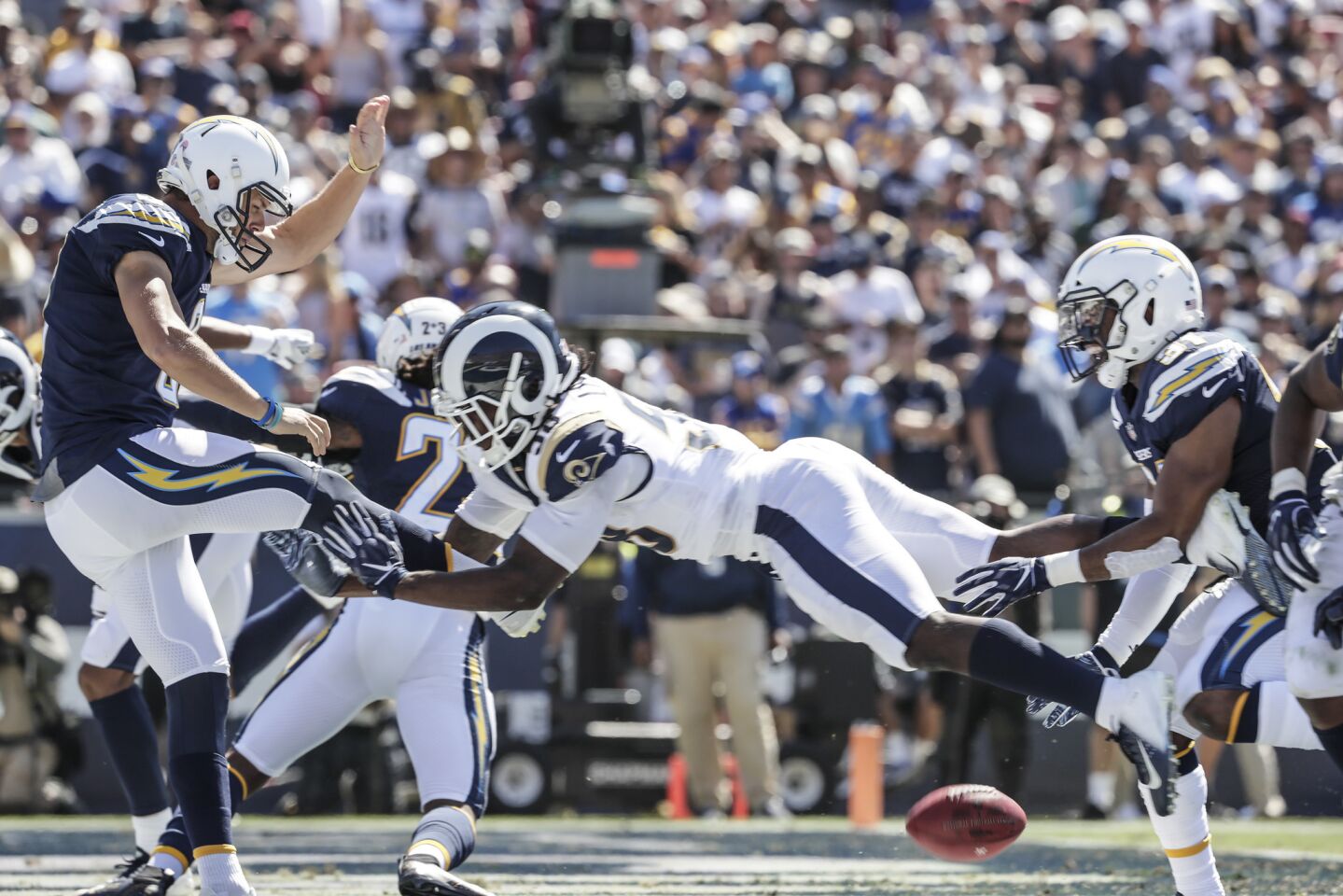 Rams linebacker Cory Littleton blocks the punt attempt of Chargers punter Drew Kaser, resulting in a second quarter Rams touchdown at the Coliseum.