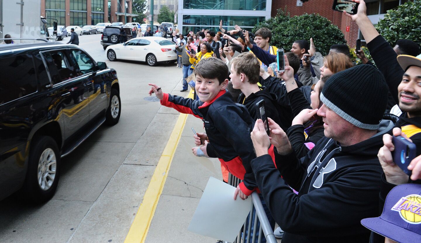 A crowd cheers as Lakers star Kobe Bryant leaves the Westin Hotel in Memphis, Tenn., in a personal vehicle to head to the arena for a game against the Grizzlies on Feb. 24, 2016.