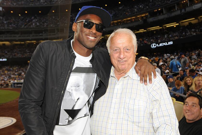 Lakers legend Kobe Bryant poses for a photo with Dodgers great Tommy Lasorda during a game at Dodger Stadium in July 2013.of the Los Angeles Lakers and Tommy Lasorda attend a game between the Los Angeles Dodgers and the New York Yankees on July 31, 2013 at Dodger Stadium in Los Angeles, Caifornia. (Photo by Jill Weisledero/Los Angeles Dodgers via Getty Images)