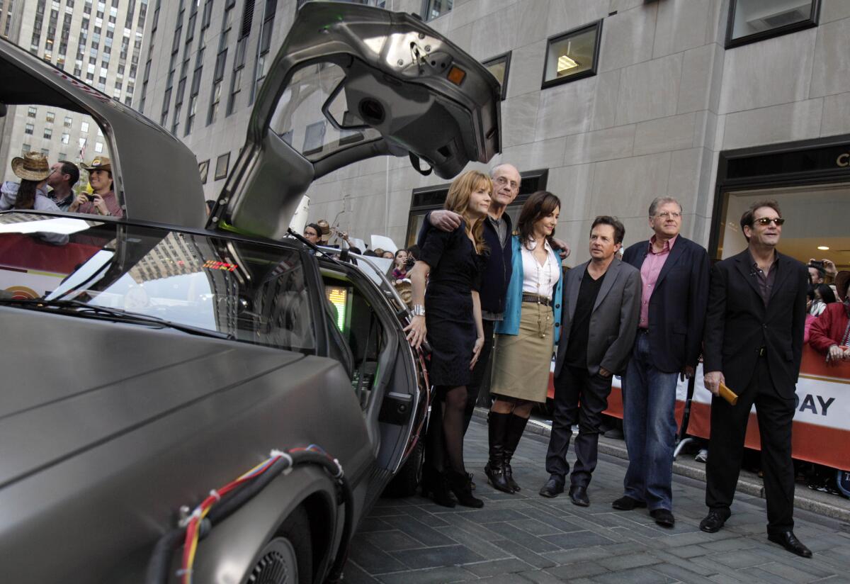  Cast members of the "Back to the Future" movies appear next to a DeLorean