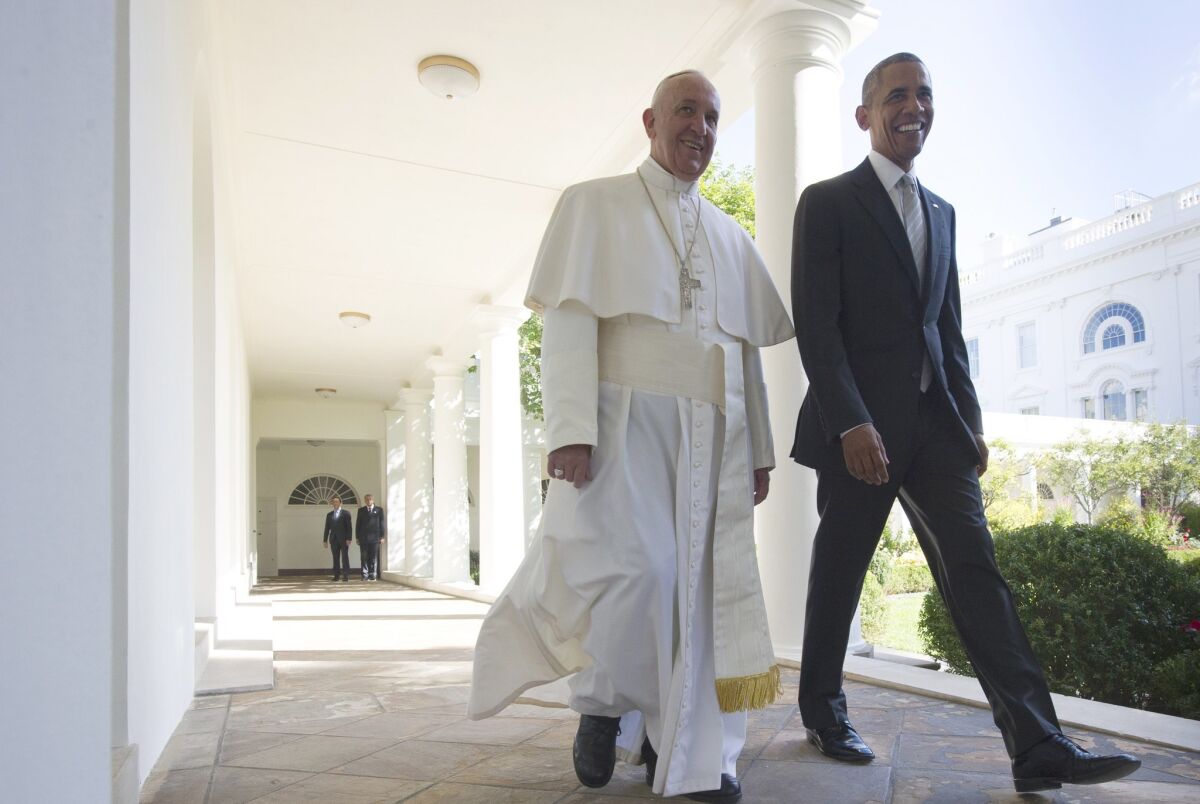 US President Barack Obama and Pope Francis walk through the Colonnade on their way to a bilateral meeting in the Oval Office of the White House on September 23, 2015 in Washington, DC.
