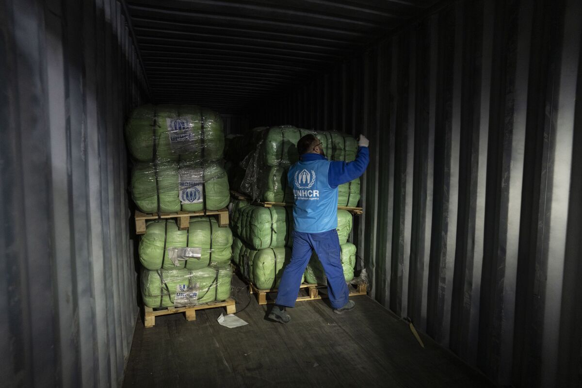 UNHCR staff load a truck with supplies for Ukraine in an aid warehouse at Rzeszow airport, in Rzeszow, southeastern Poland, Wednesday, March 16, 2022. (AP Photo/Petros Giannakouris)