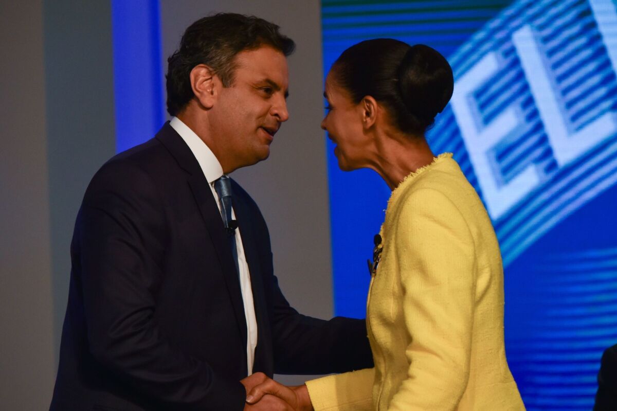 Brazilian presidential candidates Marina Silva and Aecio Neves greet each other in Rio de Janeiro before their last TV debate, on Oct. 2. Silva finished third in the first-round voting three days later.