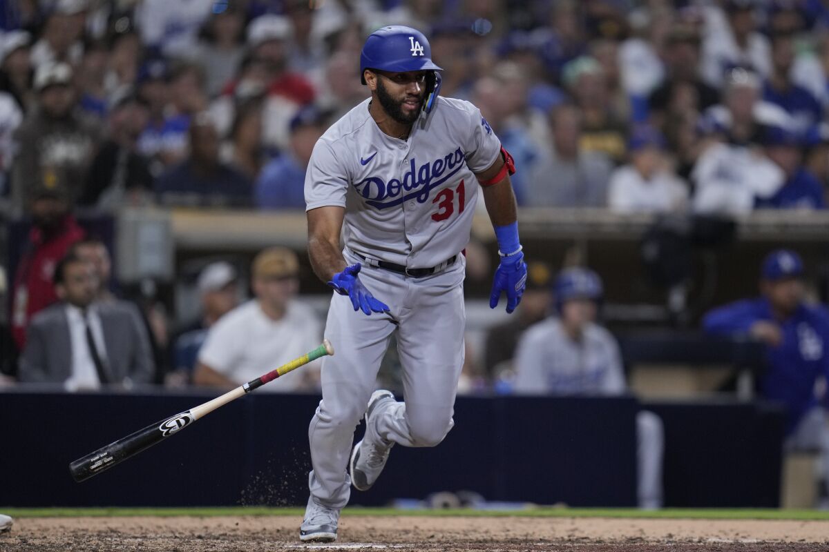 The Dodgers' Amed Rosario hits a two-run single against the San Diego Padres.
