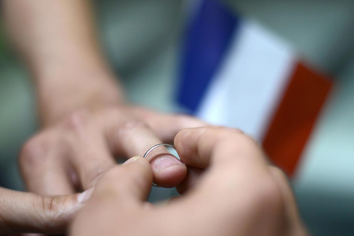 Men exchange rings in a symbolic ceremony in Paris in September 2012.