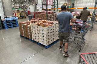 Shoppers peruse a display of Rainer cherries at a Costco warehouse Tuesday, July 11, 2023, in Sheridan, Colo. On Friday, The Commerce Department issues its June report on consumer spending. (AP Photo/David Zalubowski)