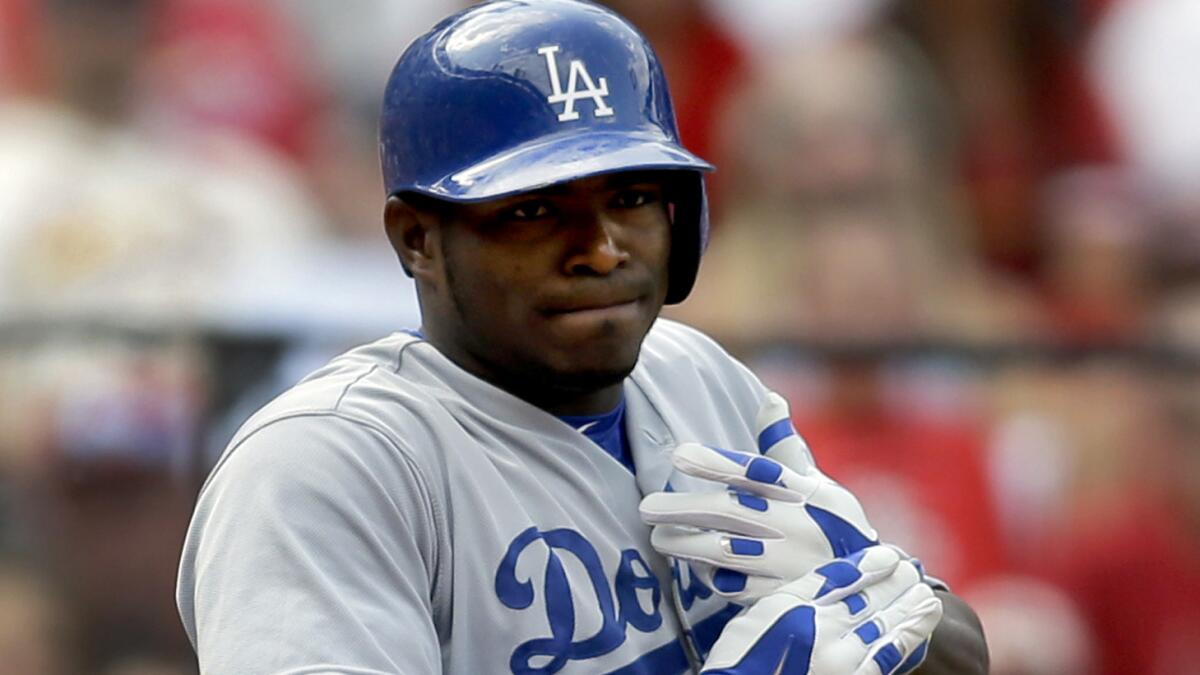 Dodgers right fielder Yasiel Puig holds his left hand after being hit by a pitch during the third inning of Saturday's loss to the St. Louis Cardinals.