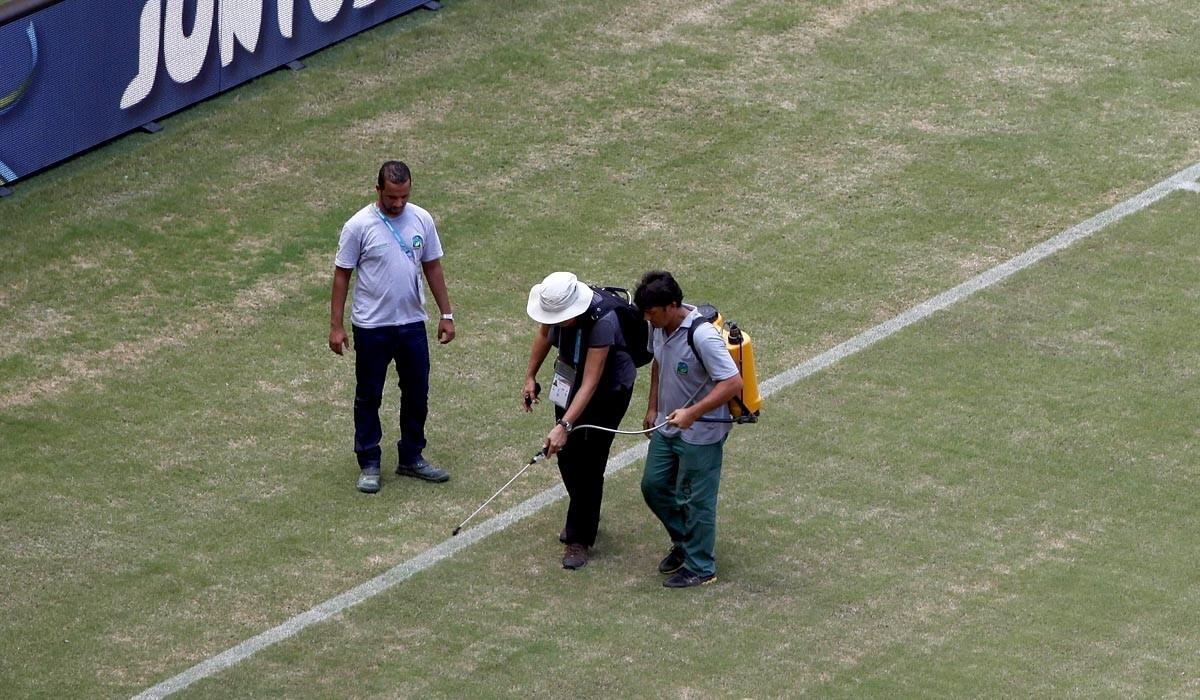 Grounds crew work on the field at Arena Amazonia in Manaus, Brazil.