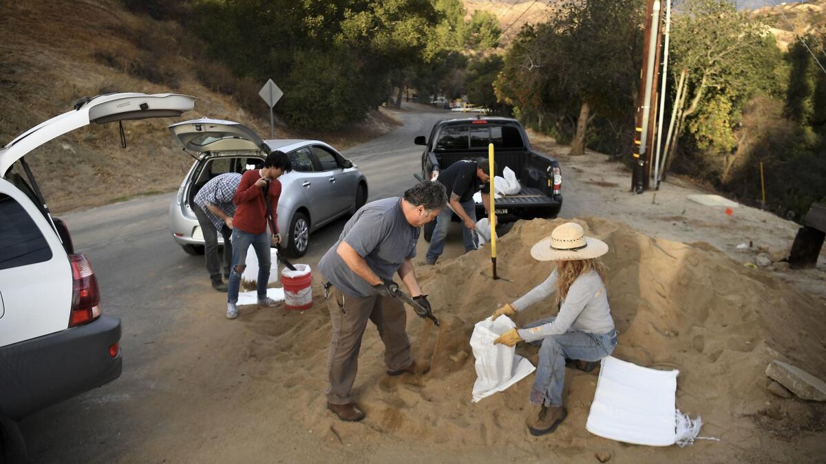 Kagel Canyon residents fill sand bags at the local fire station before a storm hits the Creek fire burn area.
