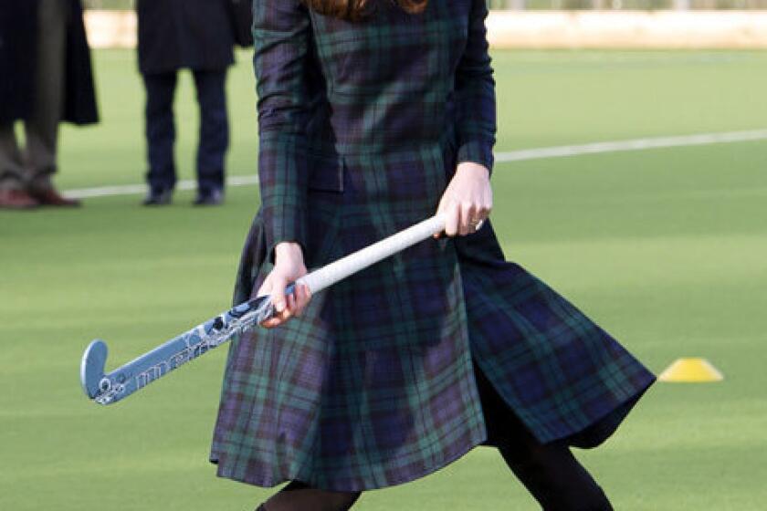 Catherine, Duchess of Cambridge, playing hockey with students Friday during her visit to St Andrew's School in Pangbourne, Berkshire, England.