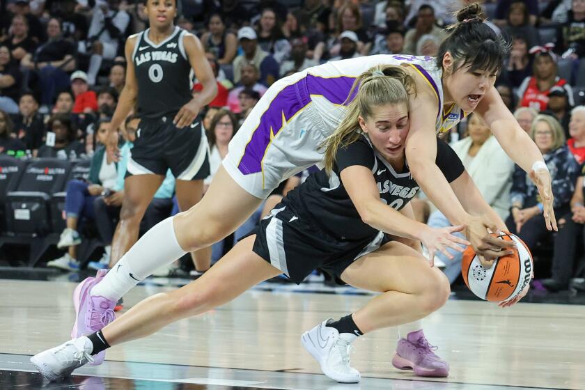 LAS VEGAS, NEVADA - MAY 18: Kate Martin #20 of the Las Vegas Aces secures a loose ball against Li Yueru #28 of the Los Angeles Sparks in the fourth quarter of their game at Michelob ULTRA Arena on May 18, 2024 in Las Vegas, Nevada. The Aces defeated the Sparks 89-82. NOTE TO USER: User expressly acknowledges and agrees that, by downloading and or using this photograph, User is consenting to the terms and conditions of the Getty Images License Agreement. (Photo by Ethan Miller/Getty Images)