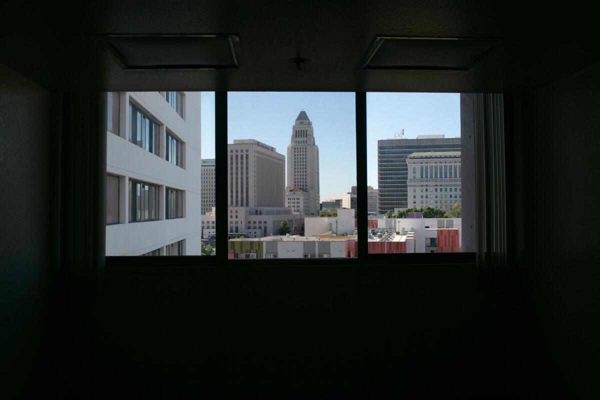 A view of City Hall from inside Cathay Manor, a building in Chinatown.
