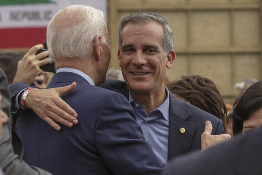 Los Angeles, CA - October 13: President Joe Biden, left, hugs Mayor Eric Garcetti during his visit to the construction site for the future terminus of the Metro D (Purple) Line near the West Los Angeles VA Campus on Thursday, Oct. 13, 2022 in Los Angeles, CA. (Irfan Khan / Los Angeles Times)