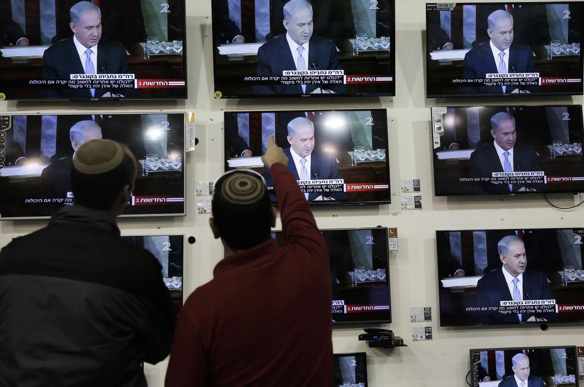 Israelis watch Prime Minister Benjamin Netanyahu address Congress in a shop in the city of Netivot on March 3.