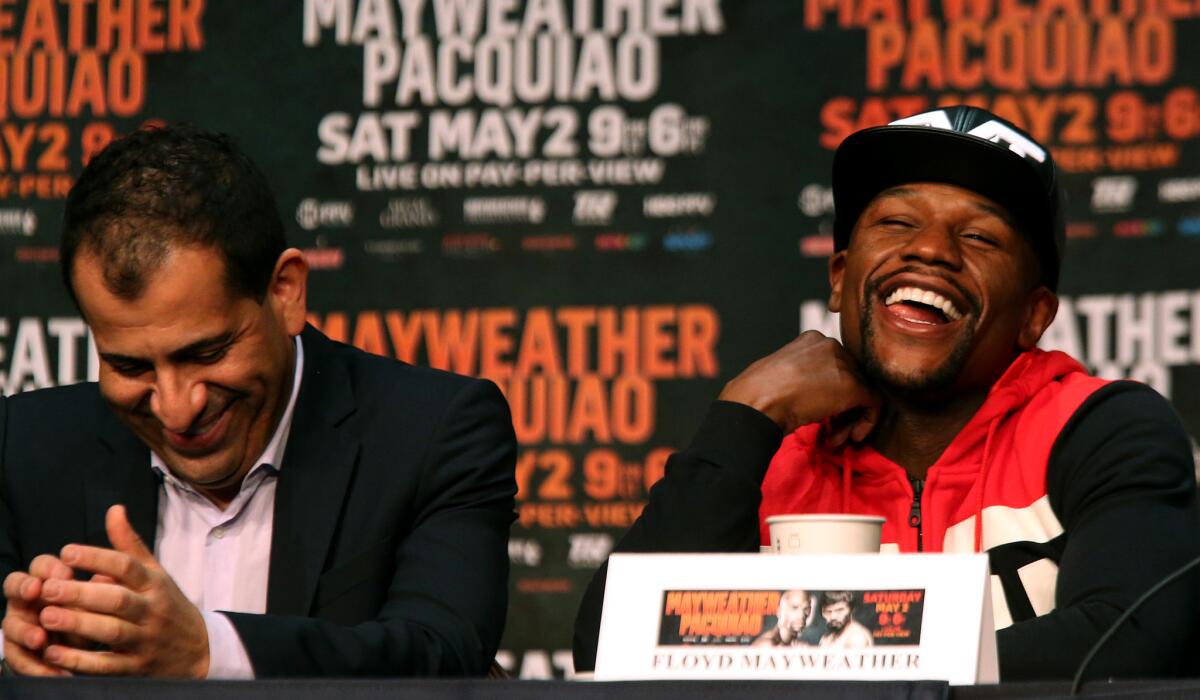 Floyd Mayweather Jr., right, and Showtime Sports Vice President Stephen Espinoza share a laugh during a news conference Wednesday at the MGM Grand Hotel in Las Vegas.