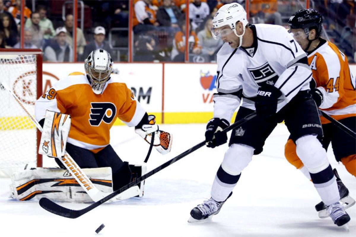 Jeff Carter tries to settle the puck in front of Philadelphia goalie Ray Emery on Monday during the Kings' 3-2 win over the Flyers.