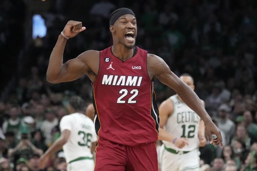 The Heat's Jimmy Butler (22) reacts after scoring against the Celtics during the second half of Game 2 on May 19, 2023.